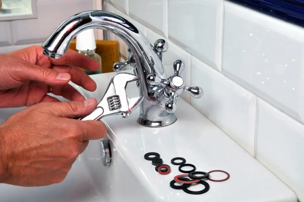 Plumber performing maintenance on a bathroom faucet in Red Oak