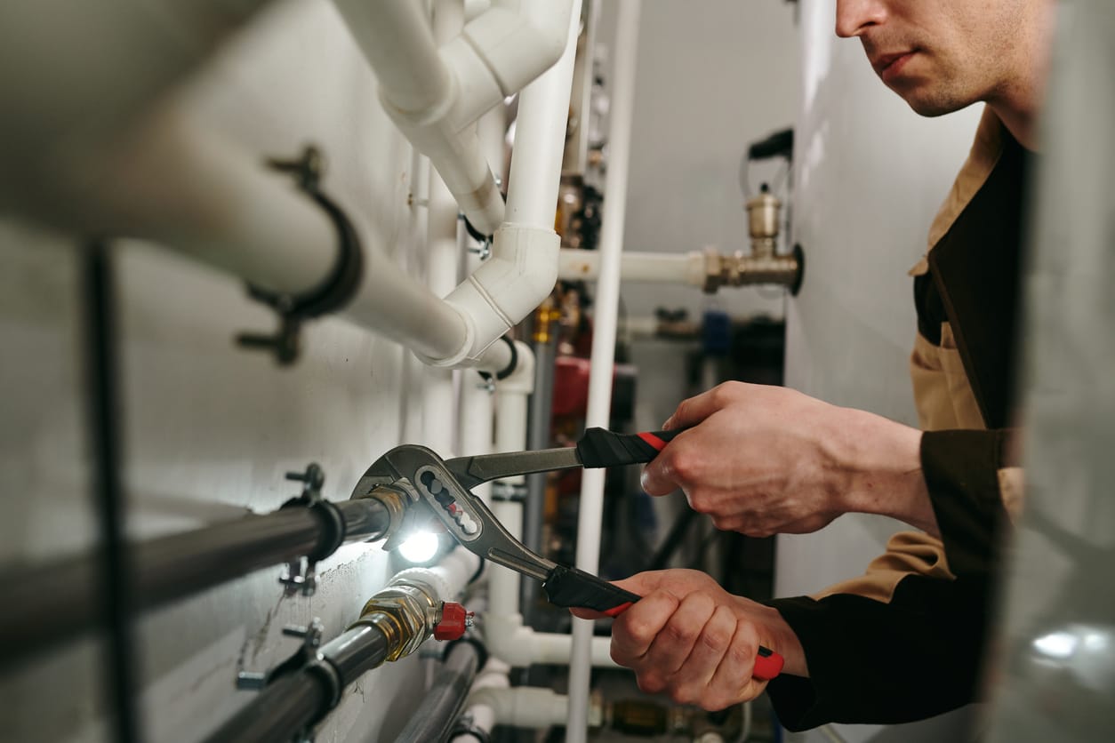 Plumbers maintaining commercial plumbing pipes in Red Oak