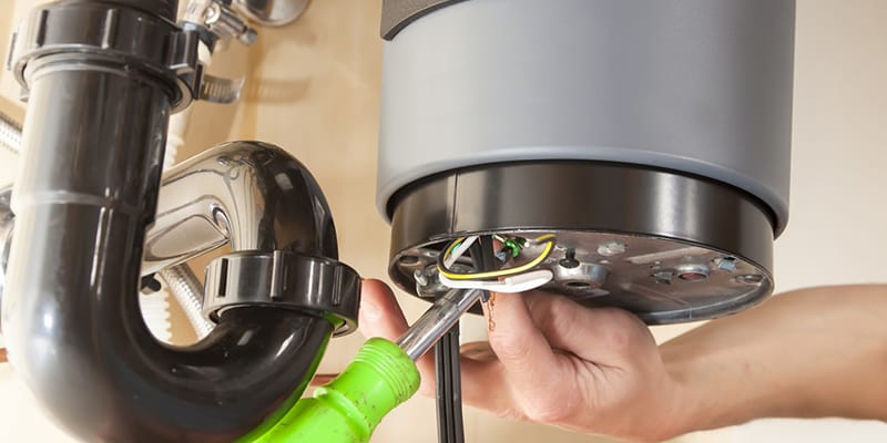 Technician repairing the heating element of a water heater in Red Oak